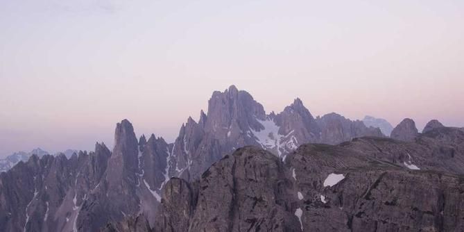 stunning mountain range, with jagged peaks and some snow-capped ridges