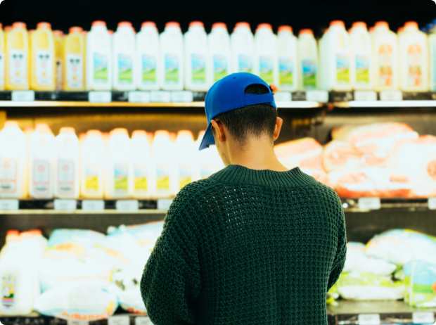 Consumer choosing packaged products with verified Product Carbon Footprint information
